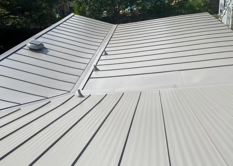 Solar attic fan installed on a metal roof for Roof Ventilation in East Grand Rapids